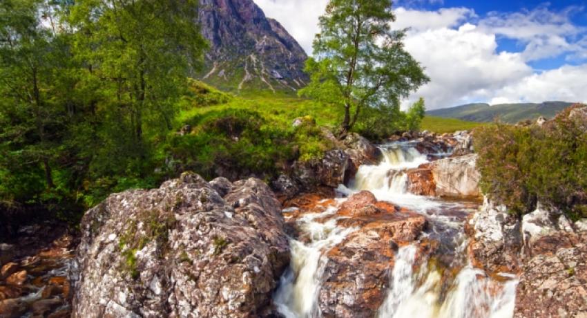 Waterfall in the foreground, hill in the background